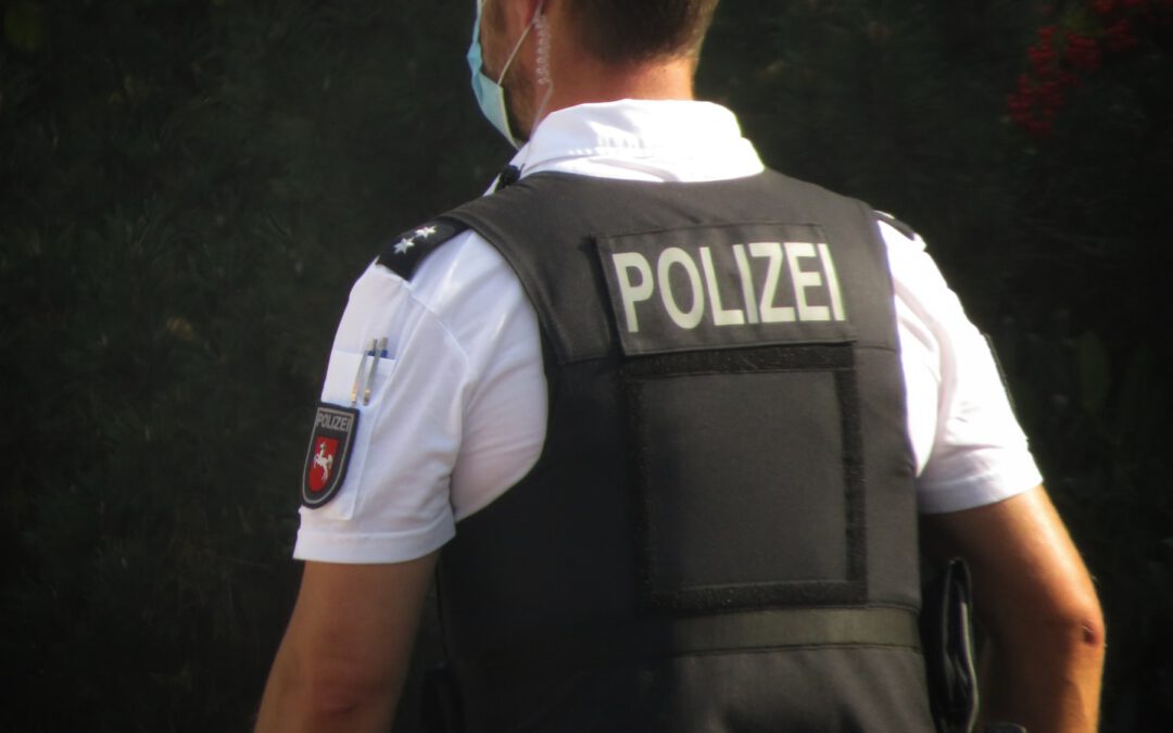 a police officer is standing in front of some trees